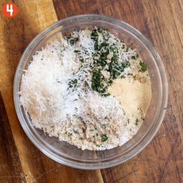 Breadcrumbs, Parmesan, Parsley, and seasonings in a bowl.