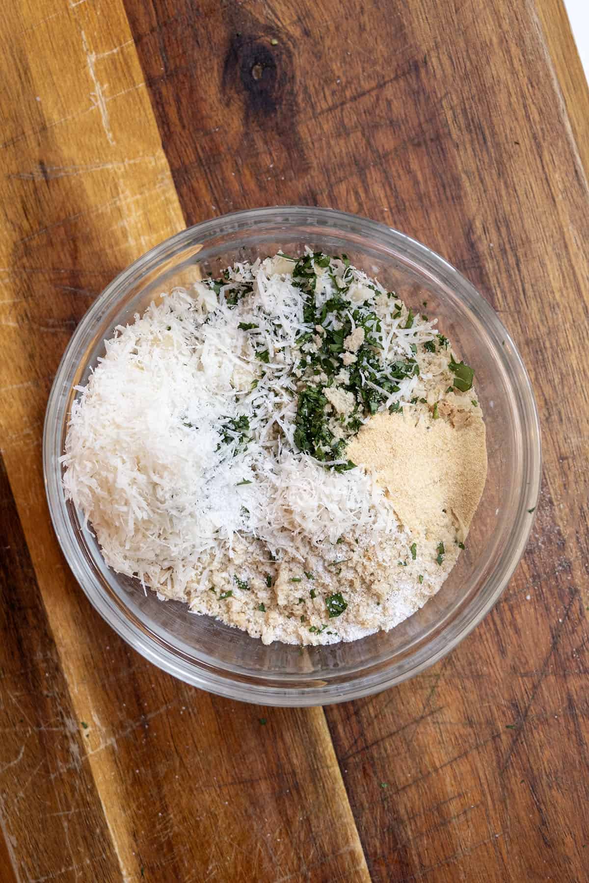 Grilled Chicken Skewers 7 A plate with a mixture of panko breadcrumbs, Parmesan cheese, garlic powder, and fresh parsley.
