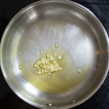 Minced garlic sauteing in the saucepan.