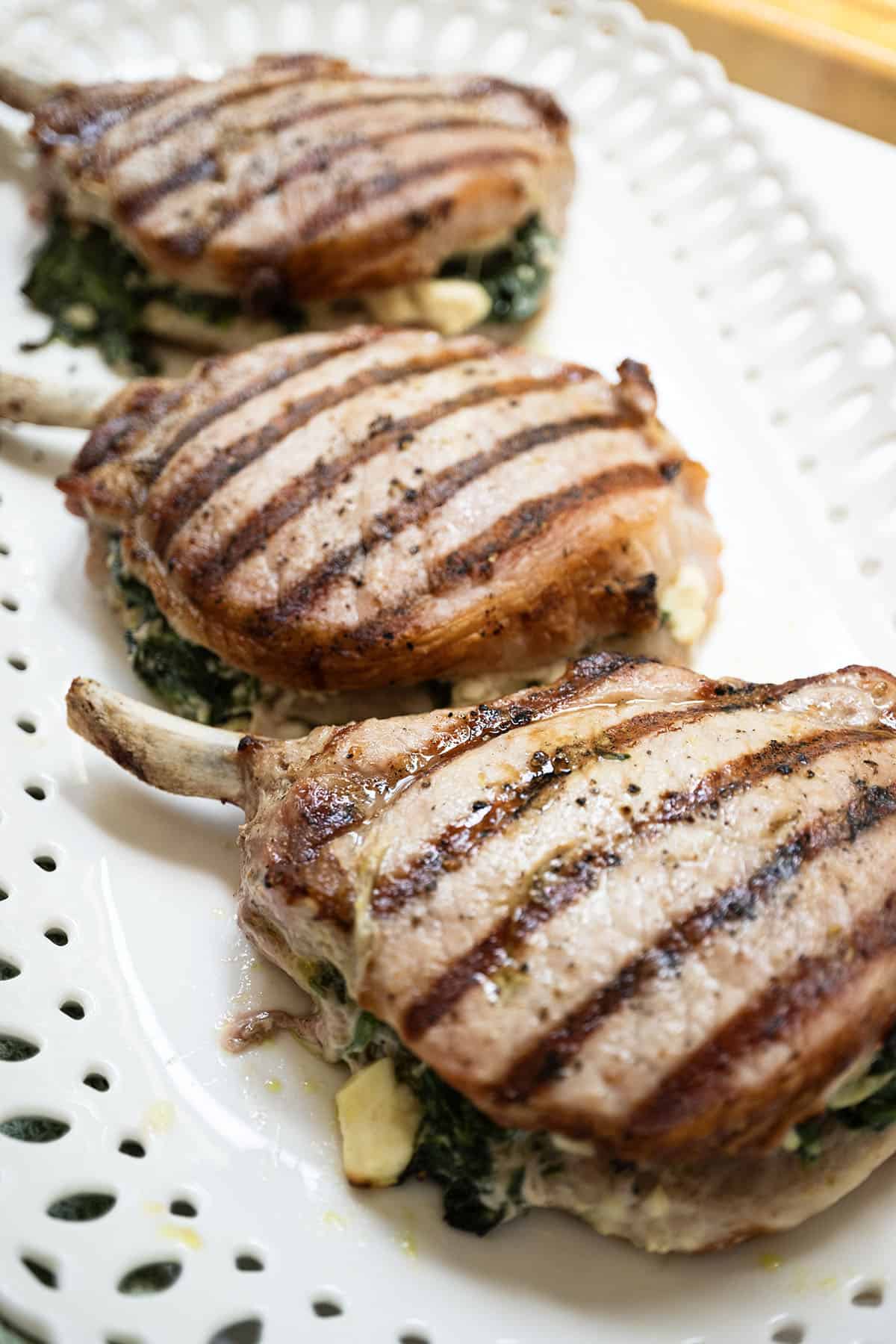 Grilled pork chop stuffed pork chops with feta and sauteed spinach and garlic.