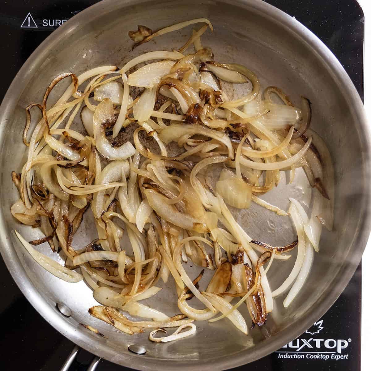 Gourmet Fig and Goat Cheese Burger 5 Onions caramelized in the frying pan.