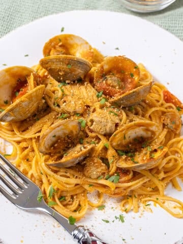 linguine with clams in red sauce on a plate.