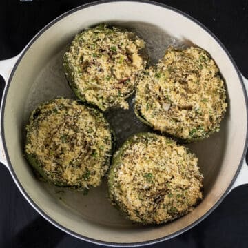 Stuffed artichokes in a dutch oven with a little bit of water.