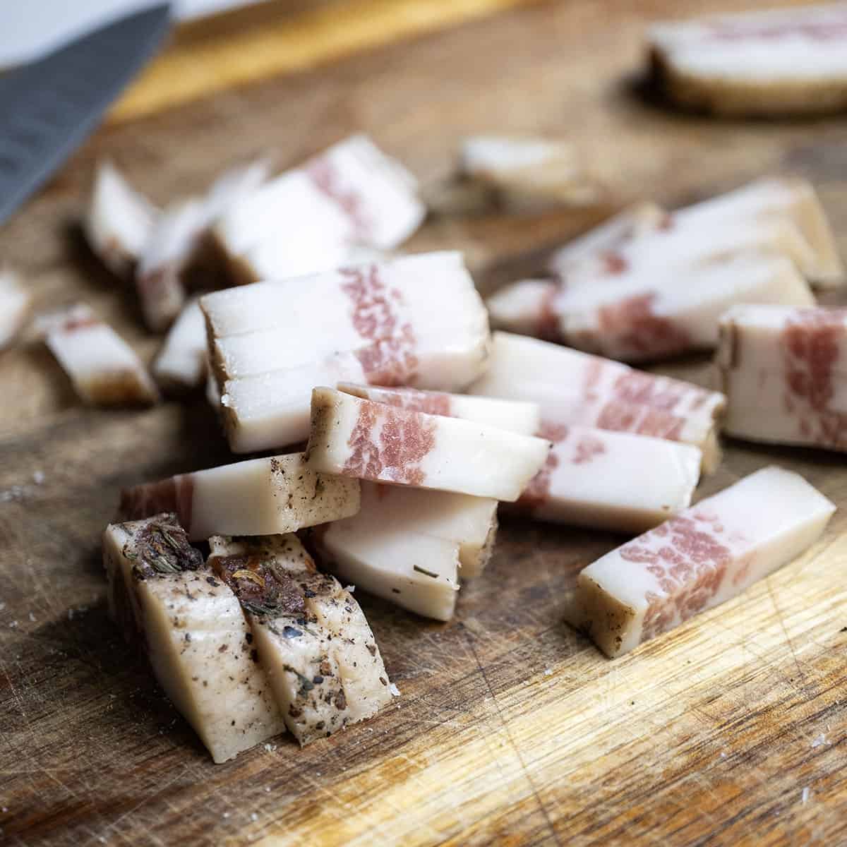 Chopped pancetta on a cutting board.