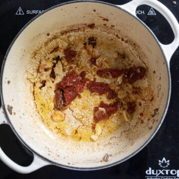 Tomato paste caramelizing in the dutch oven.