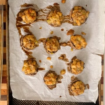 Stuffed mushrooms baked on a baking tray.