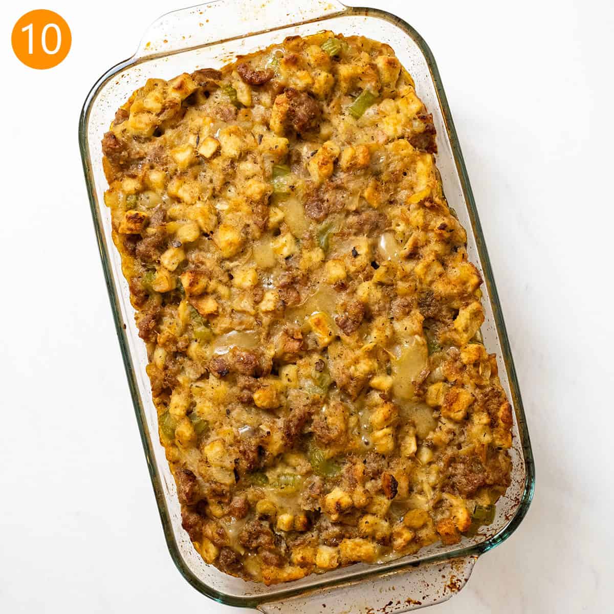 Italian sausage stuffing baked in a glass baking pan.