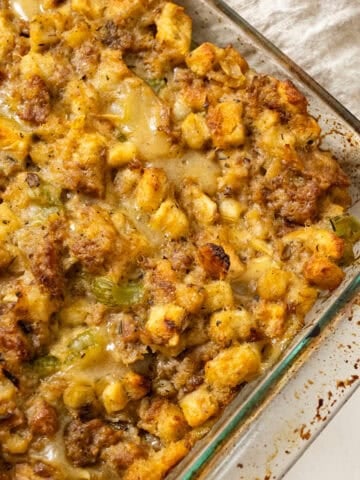 Italian sausage stuffing baked in a glass baking pan.