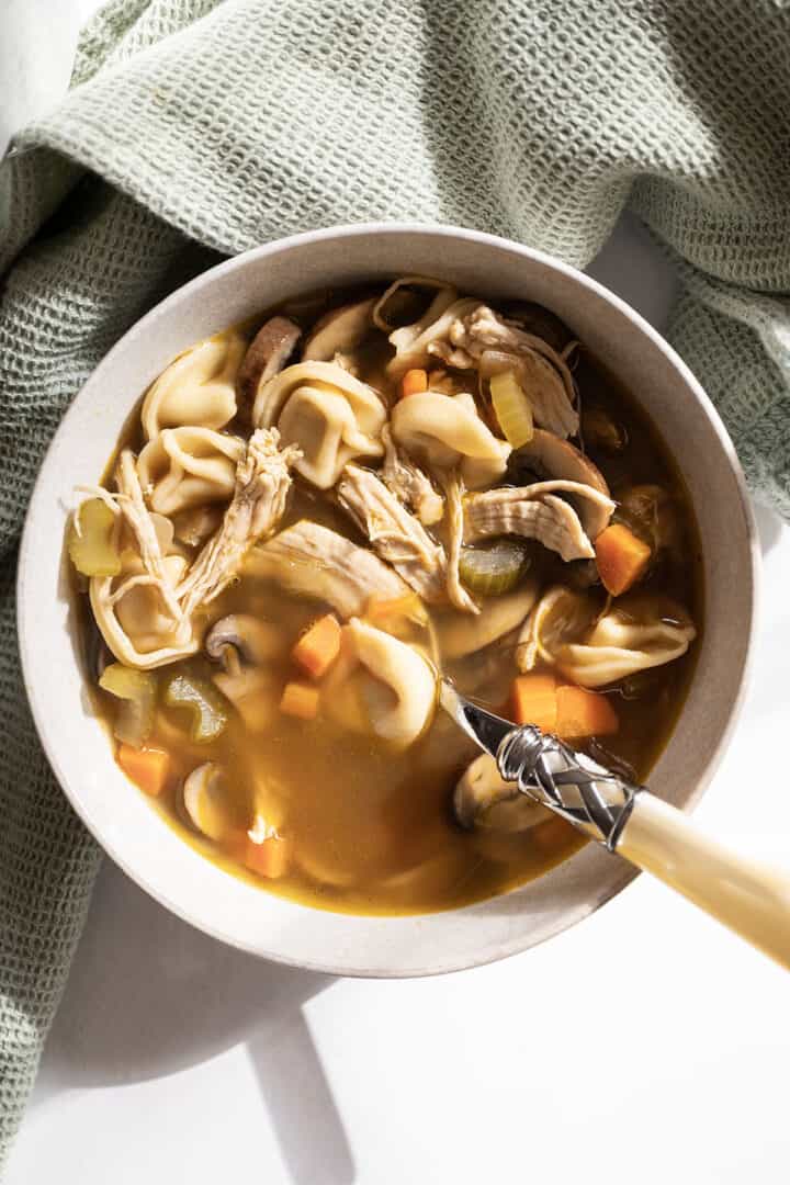 Chicken tortellini soup in a bowl.