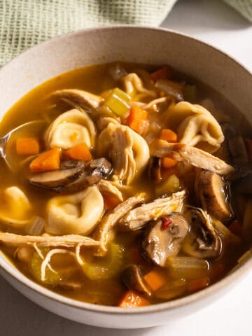 Chicken tortellini soup in a bowl.