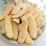 A bunch of ladyfingers on a plate.