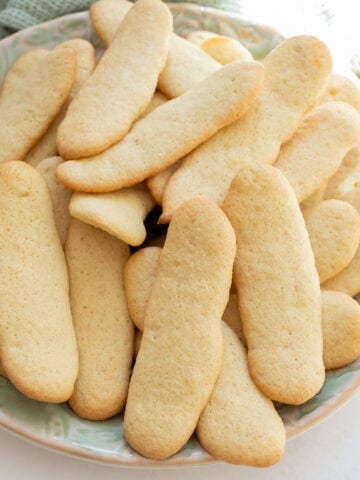 A bunch of ladyfingers on a plate.