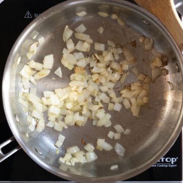 Sauteing onions in a pan.