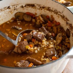 Beef and barley soup in a pot.