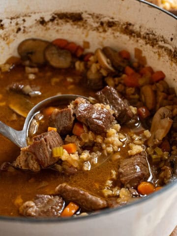 Beef and barley soup in a pot.