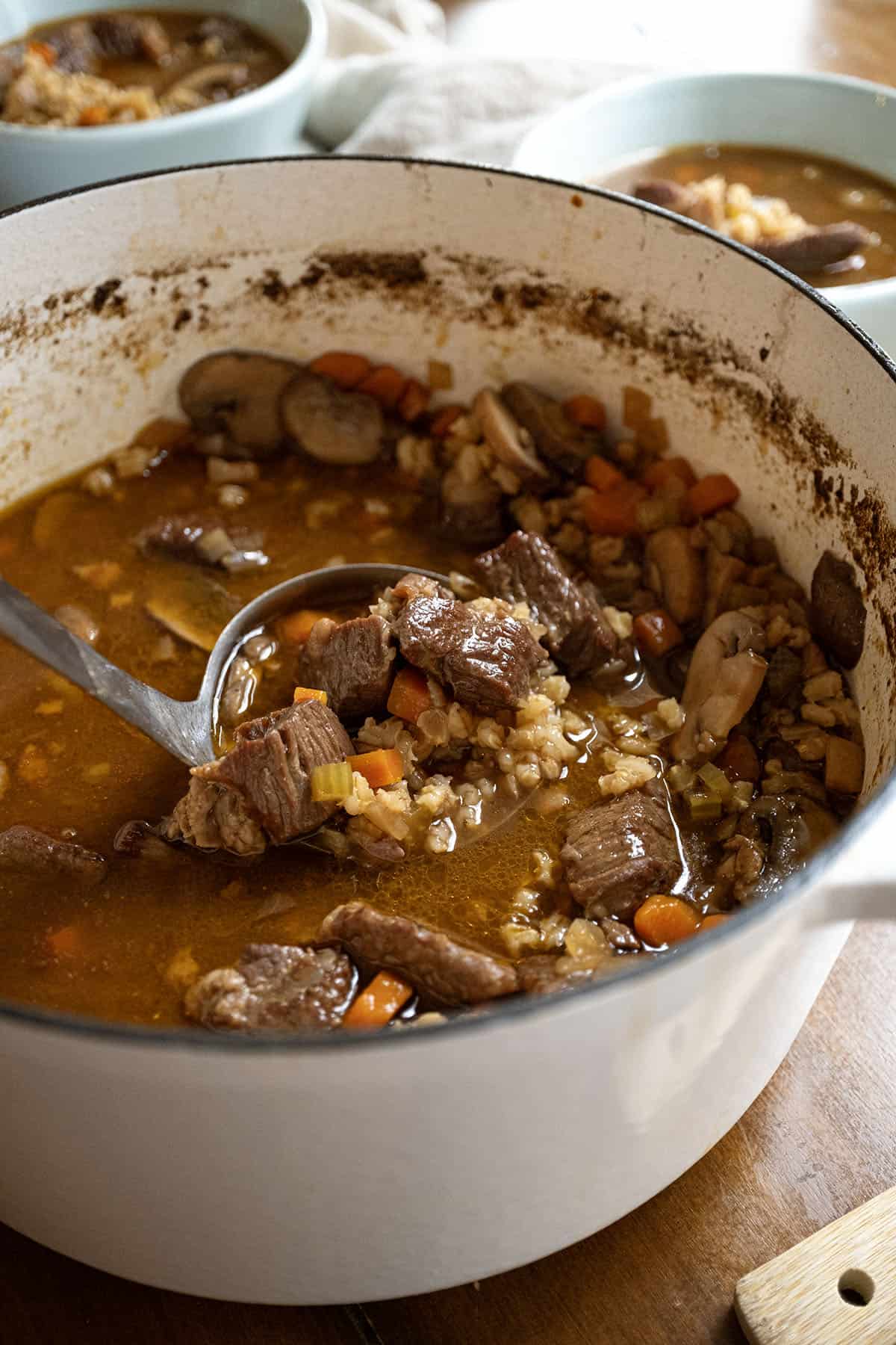 Beef and barley soup in a pot. 