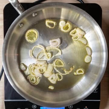 Shallots sauteing in a saucepan.