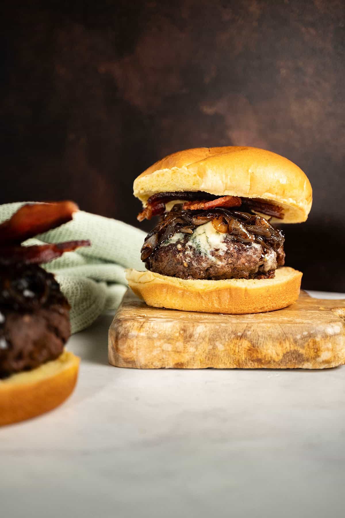 Bacon blue cheese burger on a cutting board.
