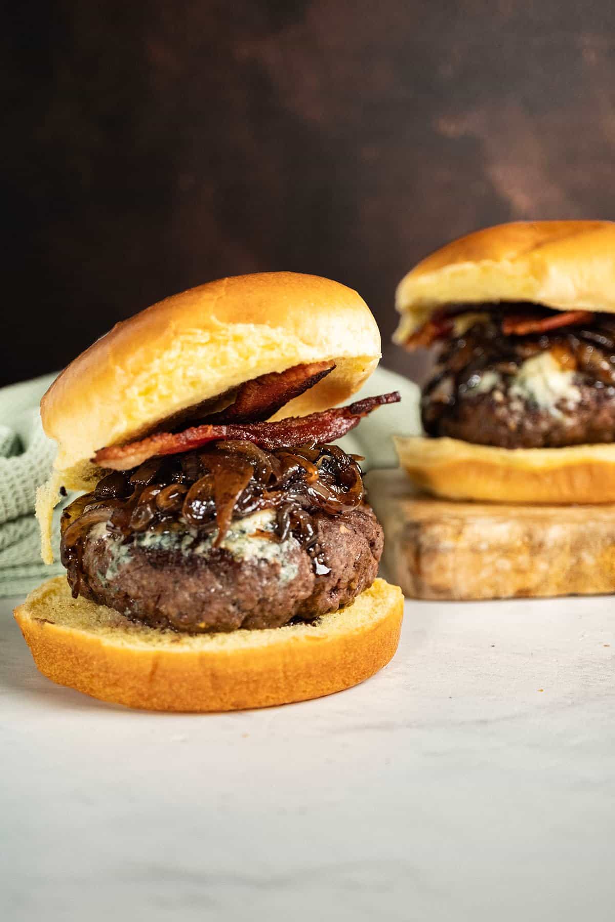 Bacon blue cheese burger on a cutting board.