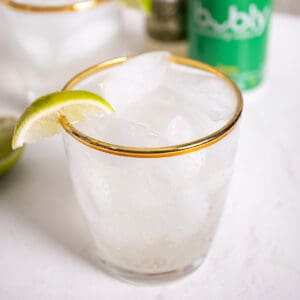 Non alcoholic moscow mule in a glass, garnished with a lime.