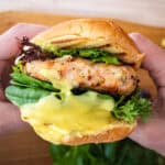 Grilled chicken burger on a bun with garlic aioli.