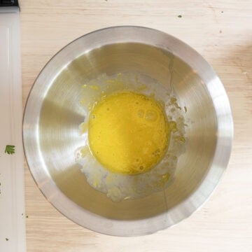 Slowly whisking olive oil, egg yolk, and garlic. 