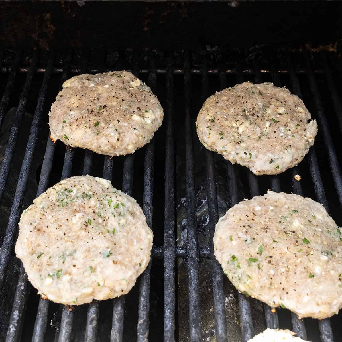 Grilling Chicken burgers on the grill.