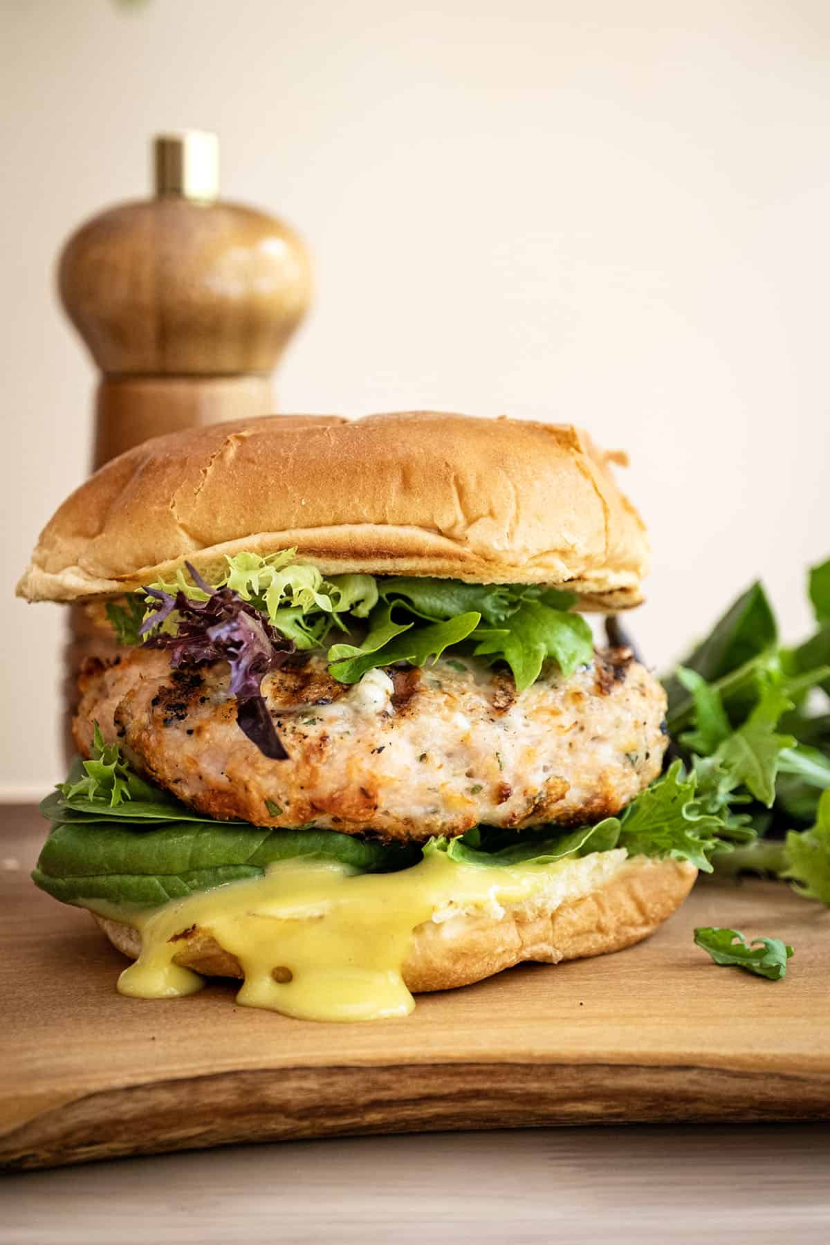 Grilled chicken burger on a bun with garlic aioli.