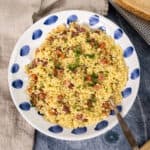Pastina with pancetta and parsley in a bowl.