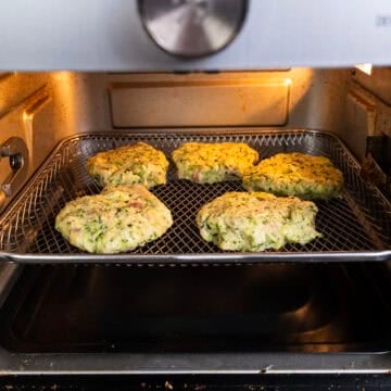 Air frying zucchini fritters.
