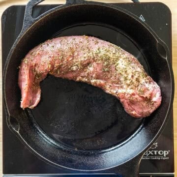 Searing pork tenderloin on the cast iron pan.