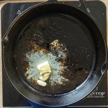 Sauteing butter and garlic in the cast iron pan.