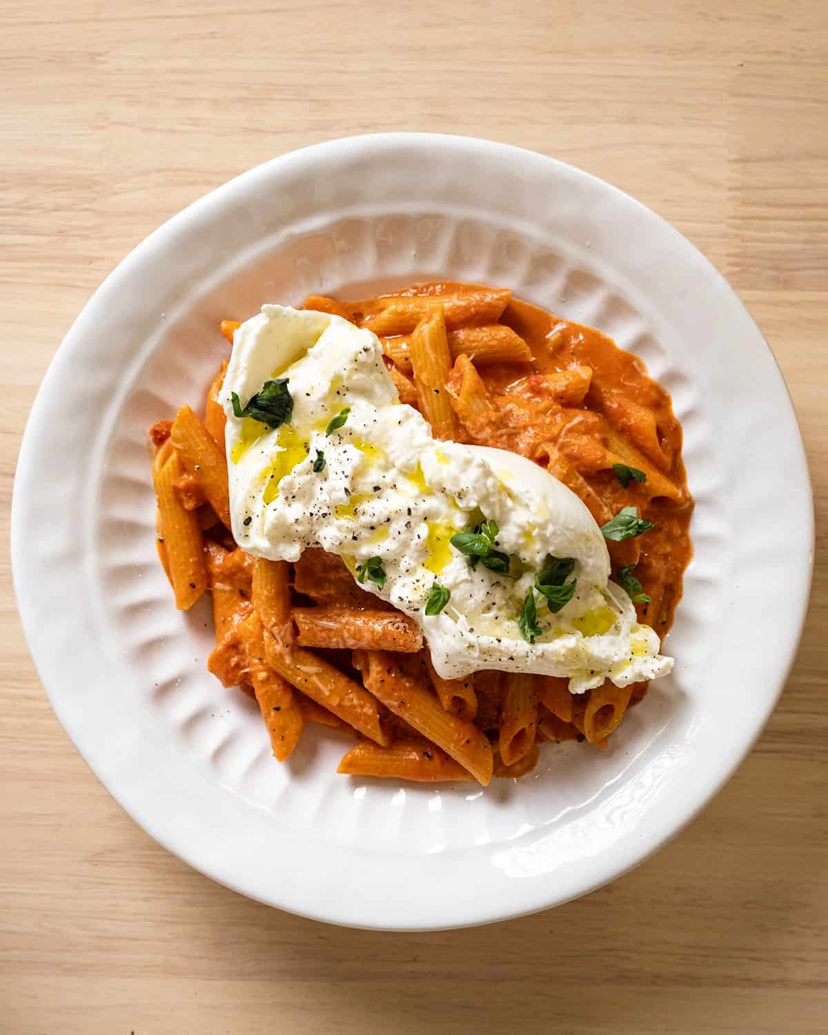 Penne a la vodka topped with burrata.