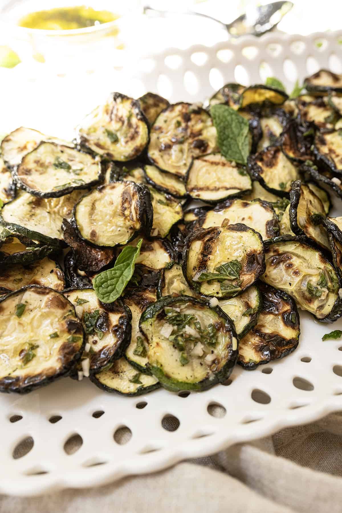 Zucchini alla scapece on a tray garnished with mint.