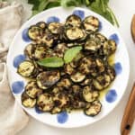 Zucchini alla scapece on a plate topped with mint.