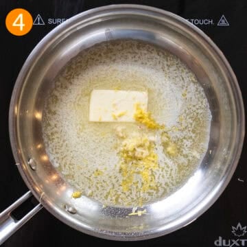 Simmering garlic in butter with lemon zest.