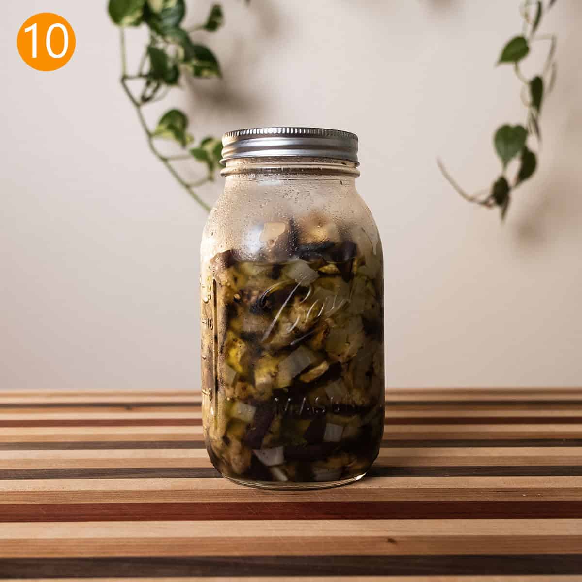 Eggplant and onions marinating in a mason jar.