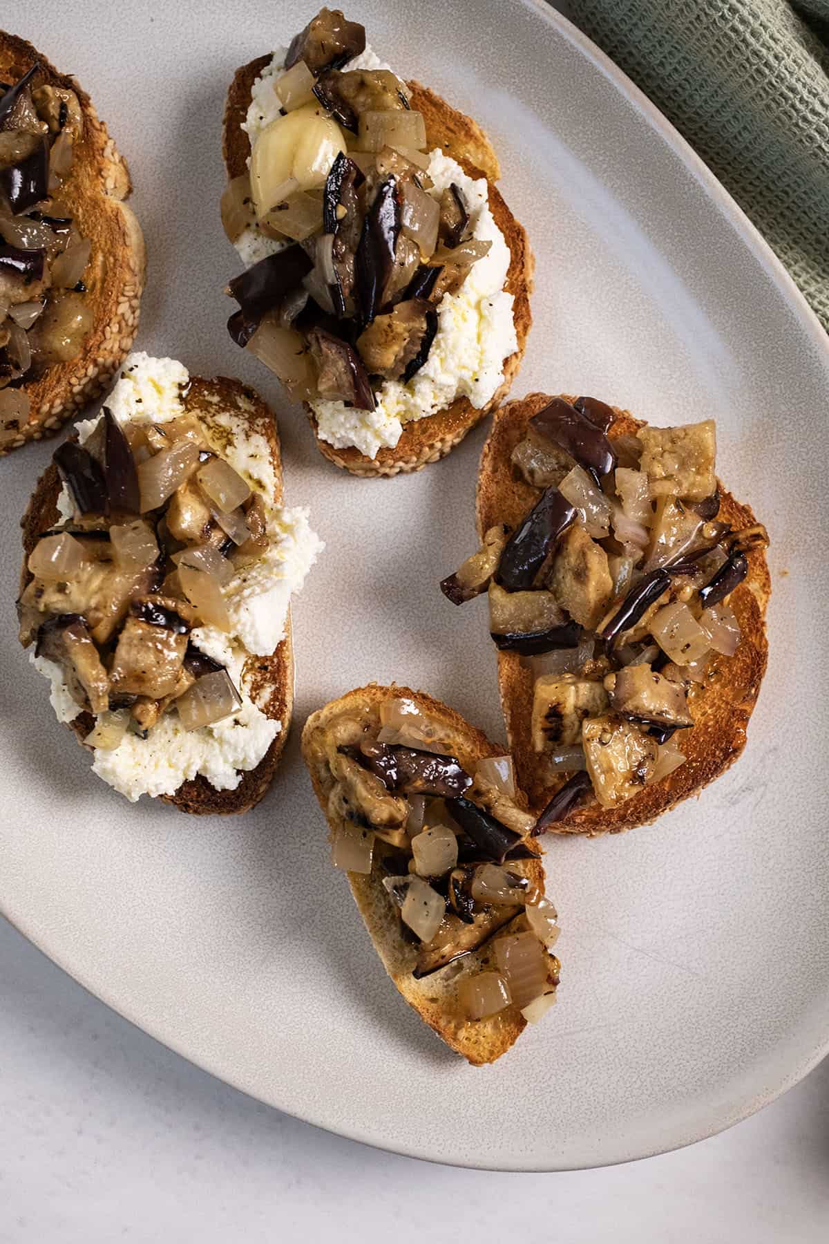 Marinated eggplant on toast with ricotta.