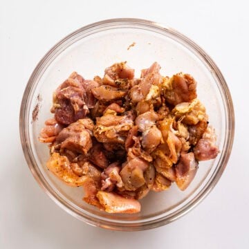 Chicken thighs tossed in olive oil and seasoning.