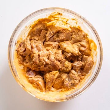Chicken thighs marinated in chipotle mayo and seasoning.