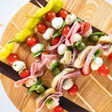 Vegetables, cheese, and salami on a skewer.