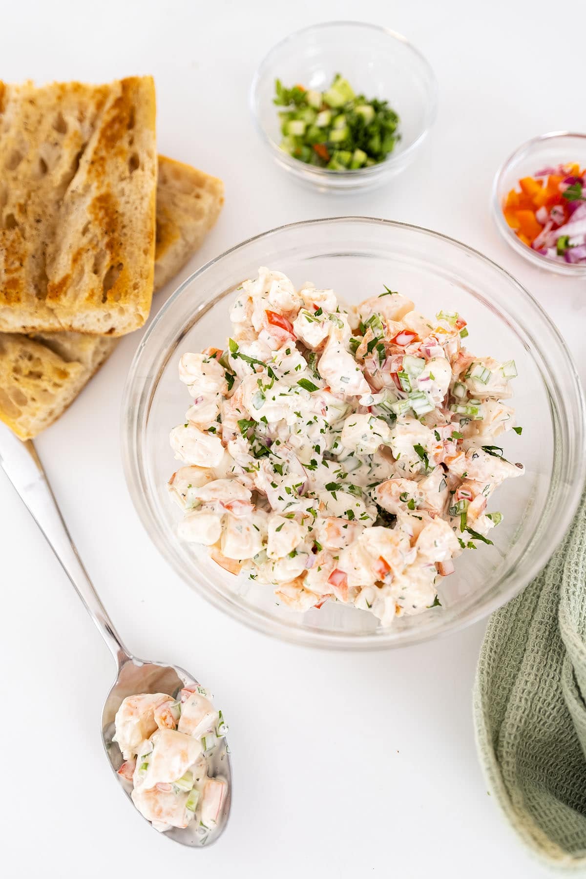 Cold shrimp salad in a bowl with a side of toasted bread.