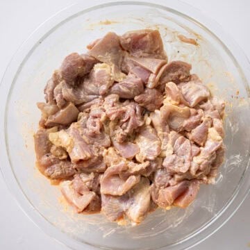 Marinating grilled chicken in a bowl.