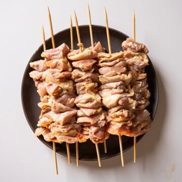 Marinated chicken thighs on skewers.