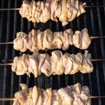Grilling chicken thigh skewers.