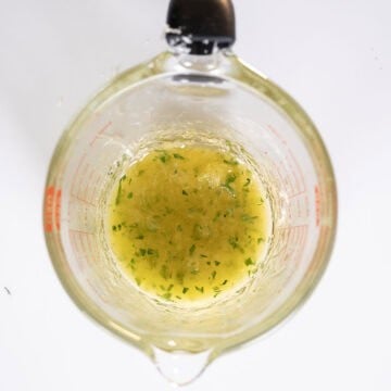 Lemon garlic butter sauce in a measuring cup.