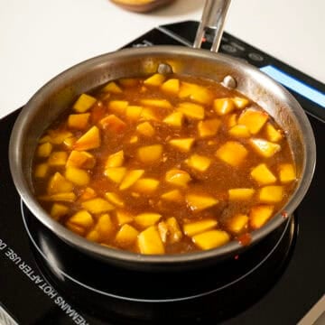 Peaches simmering in the sauce. 