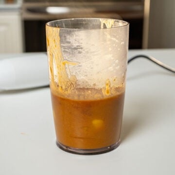 Bourbon peach sauce blended in a measuring cup.