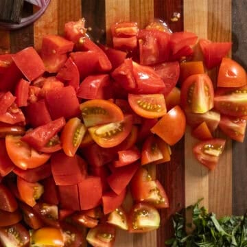 Chopped tomatoes on a cutting board.