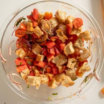 Bread soaking with tomatoes and vegetables.